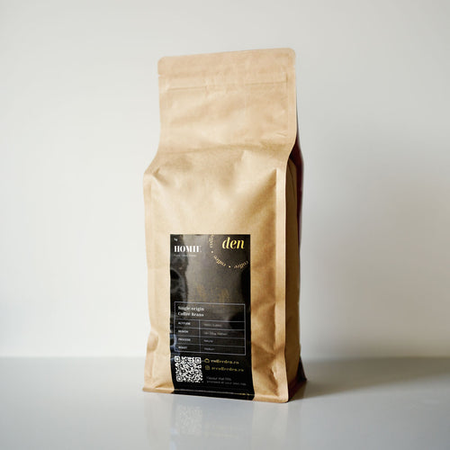 Kraft paper coffee bag with a black label on a light grey background