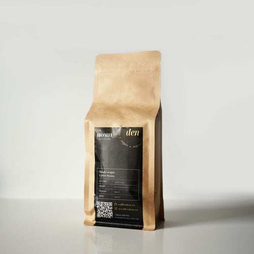 Kraft paper coffee bag with a black label on a light grey background